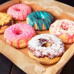 Freshly made homemade donuts using donut mix, glazed and topped with colorful sprinkles"