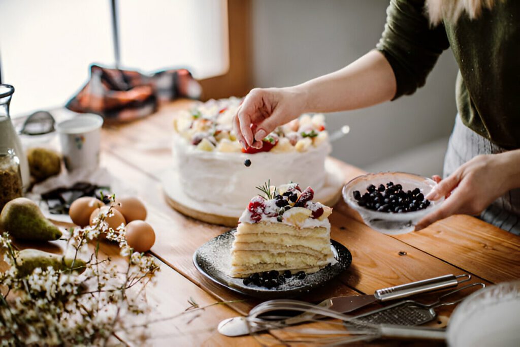 Types of cakes – classic, layered, sponge, chocolate and eggless varieties displayed on a wooden table